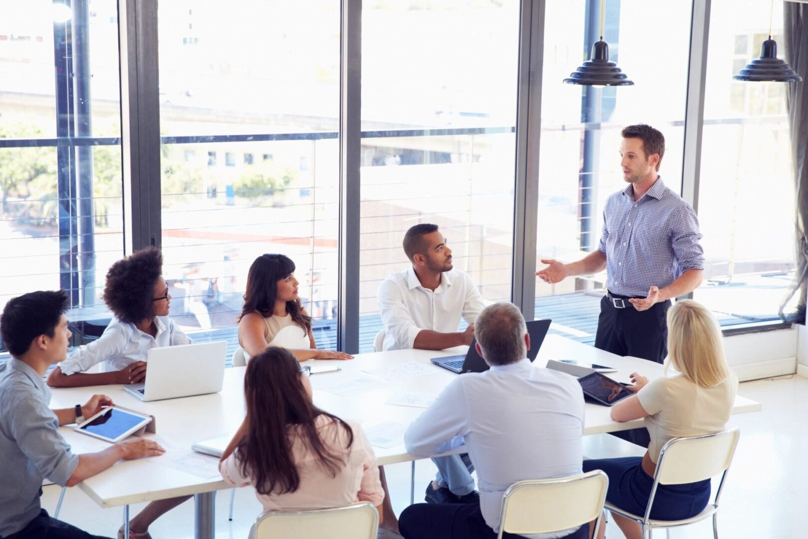 Group of professionals sitting around a table, engaged in important business decisions and strategic discussions.